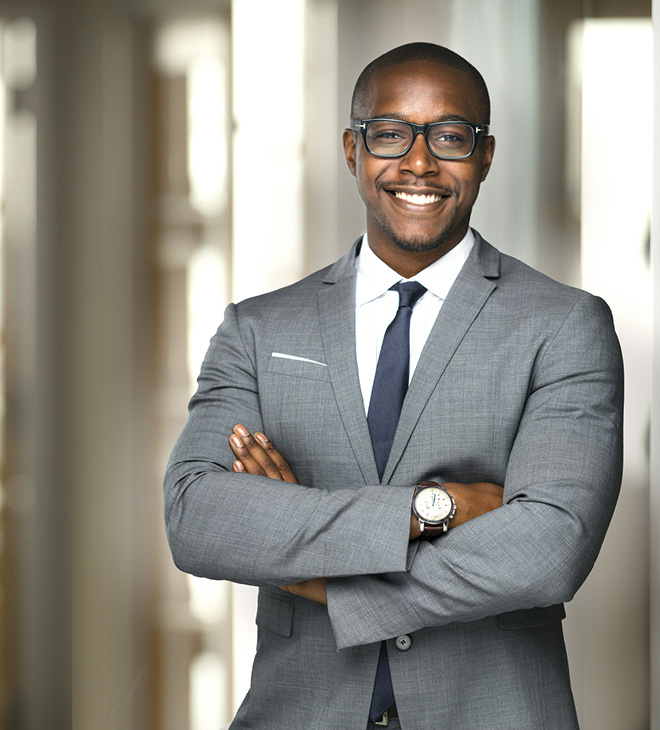 Handsome cheerful african american executive business man at the workspace office.jpg